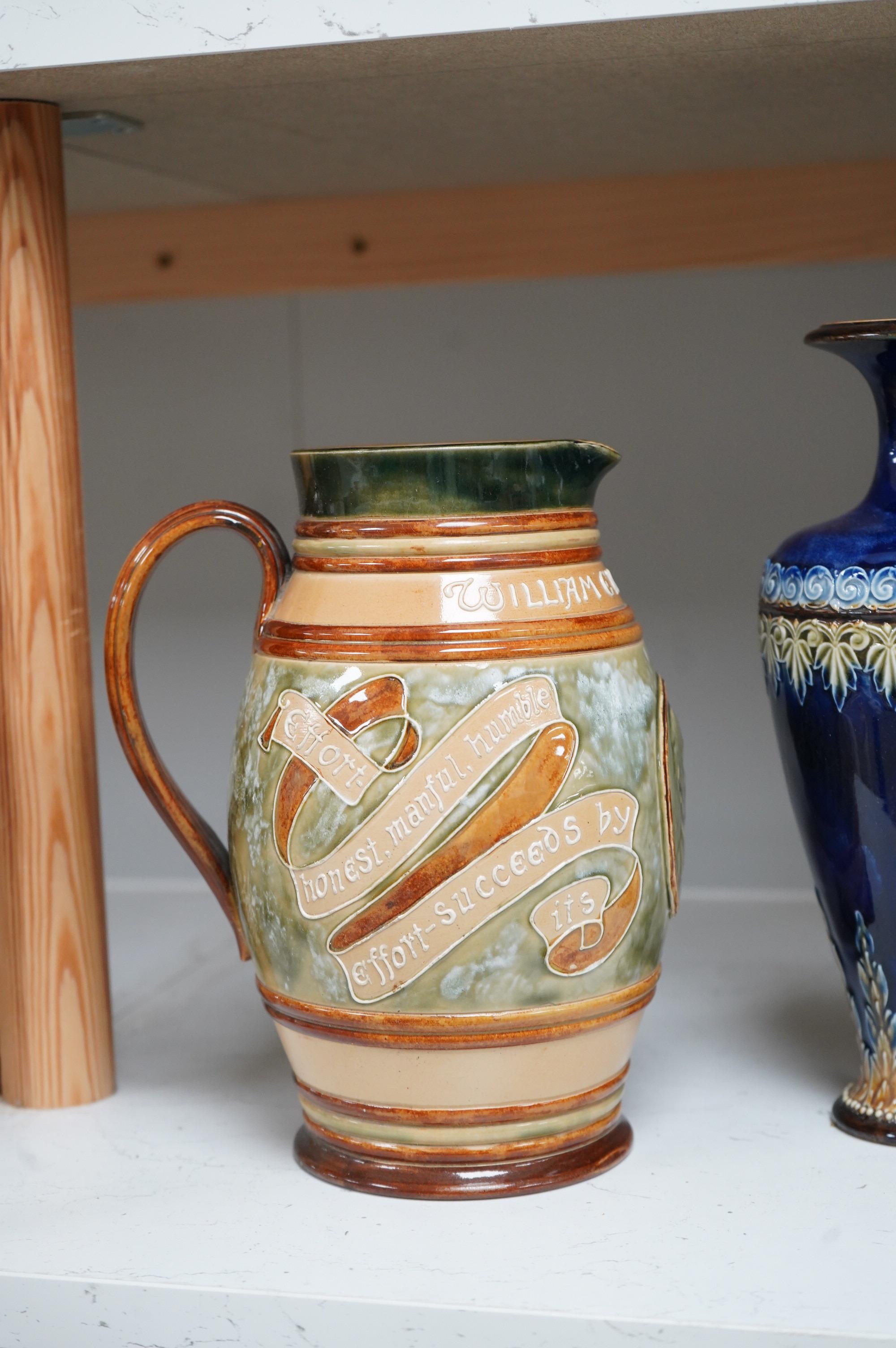 A Doulton Lambeth stoneware commemorative pitcher of William Ewart Gladstone 23cm high, together with a pair of vases two handled vase and a mug, (5).